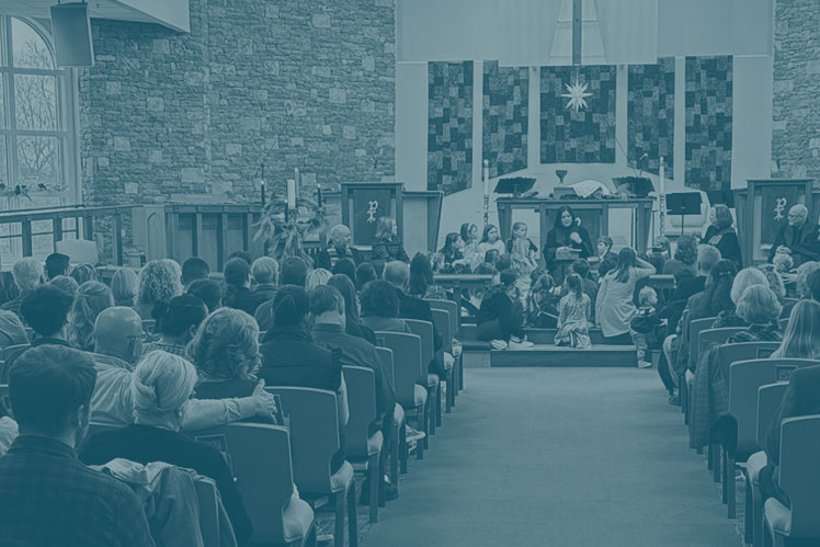 Children sit at the altar and listen to the children's sermon on Sunday morning at Christ UMC.