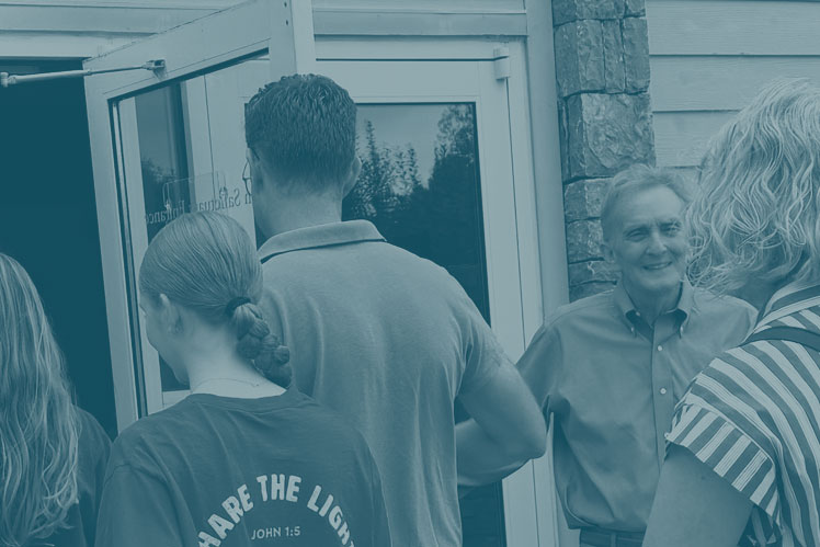 Greeter at main sanctuary doors greets visitors at Christ UMC in Franklin, Tennessee.