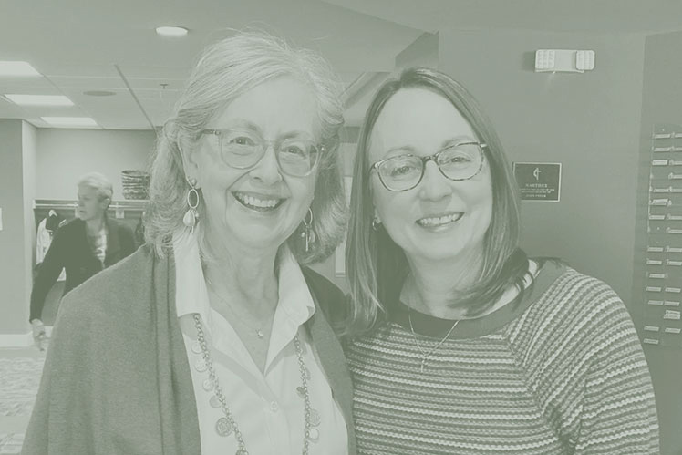 Two close women friends and members of Christ UMC smile at the camera with arms around each other.