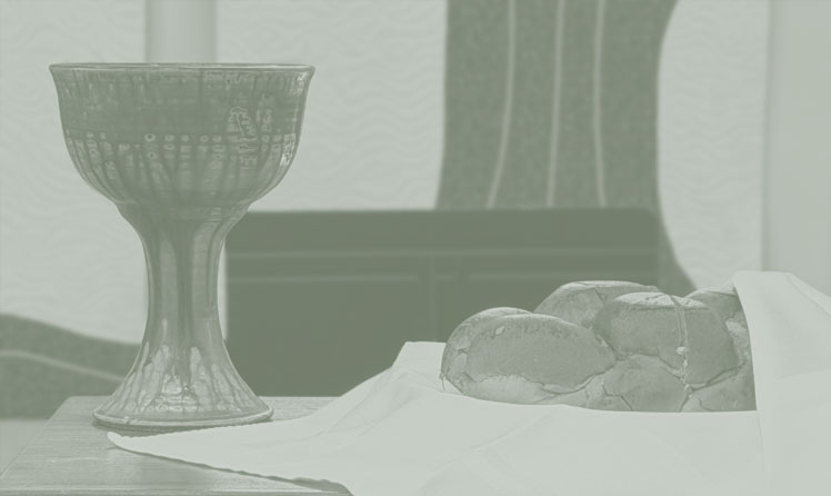 Communion table setup for service with bread and cup.