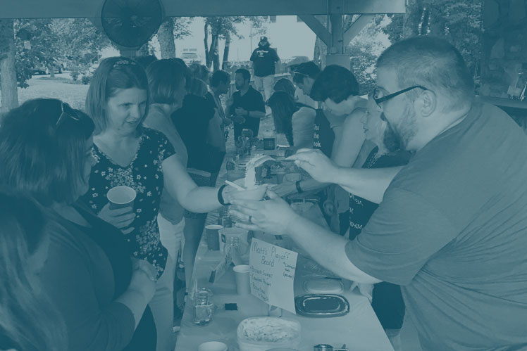 Guests try samples of homemade icecream served by contestants in a Christ UMC Firefly Festival Ice Cream Contest.
